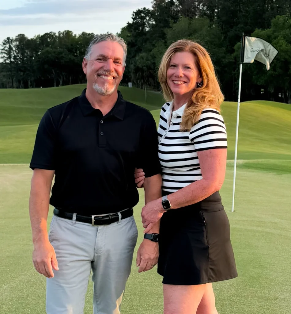 Portrait of The Par Experience owners posed on the golf green